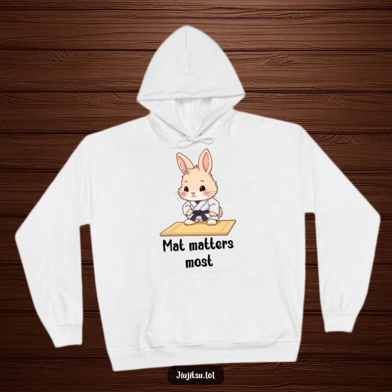 Funny Rabbit Judo Mat Study Hoodie: A curious fluffy rabbit in a judo uniform intently studies a mat, offering warmth and intellectual humor.
